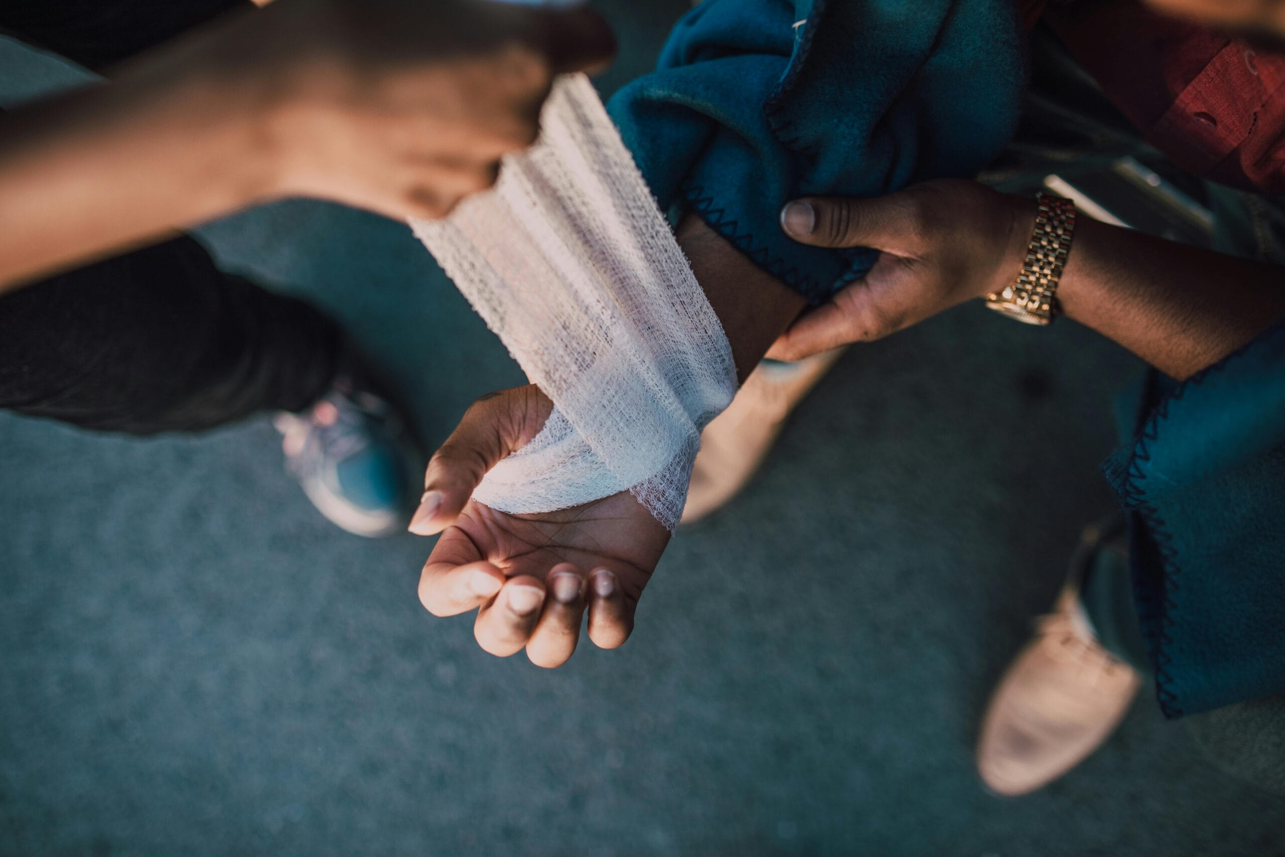 Emergency First Aid at Work bandaging an arm